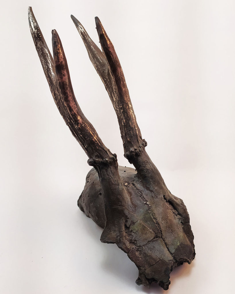 Bronze sculpture of a skull molded from a skull found in the Czech Republic